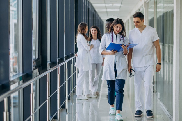 team-young-specialist-doctors-standing-corridor-hospital_1303-21202